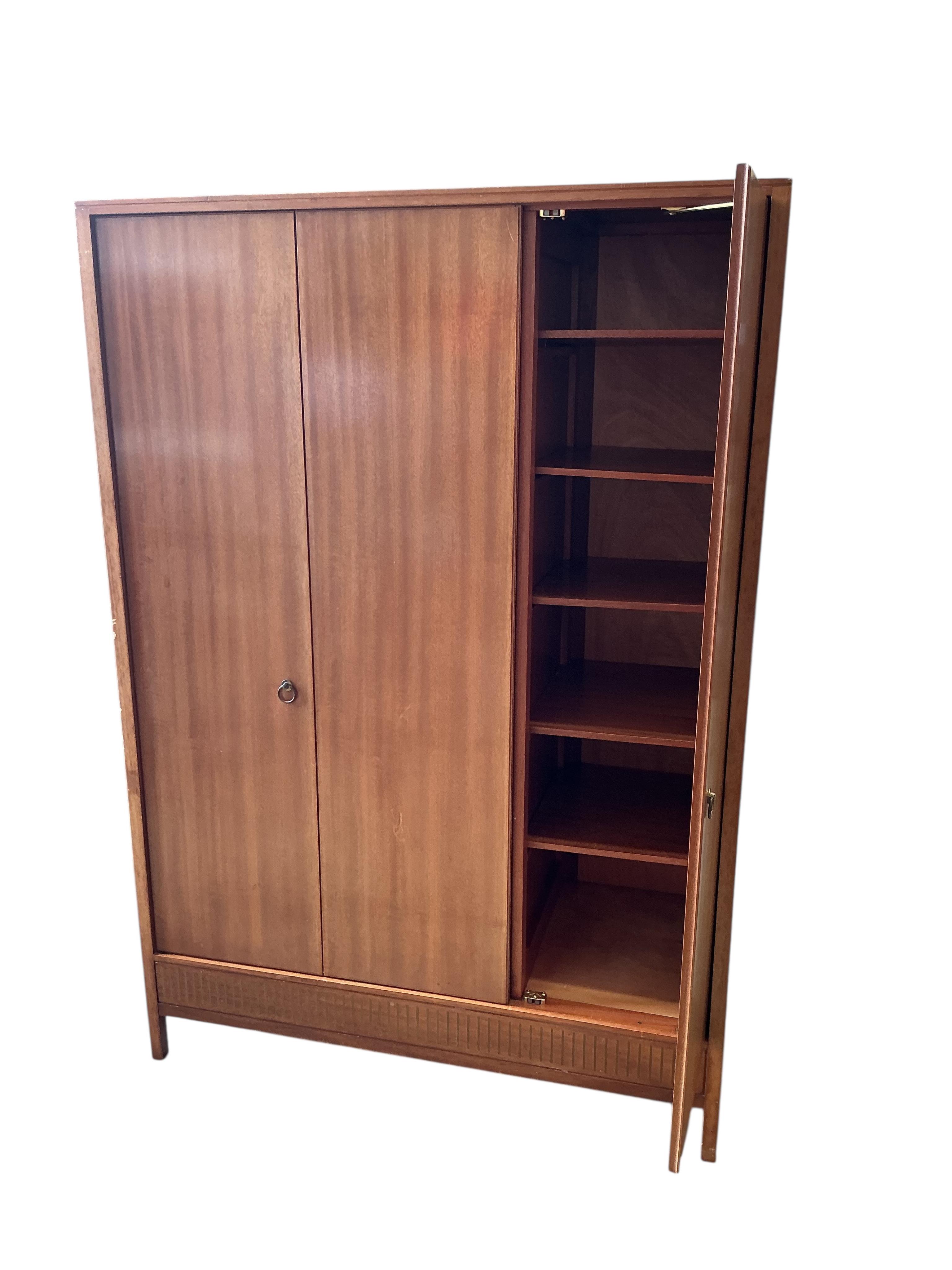 A Loughborough For Heals brass inlaid teak four piece bedroom suite comprising: triple wardrobe, width 120cm, depth 54cm, height 176cm, two chests of drawers and a toilet mirror